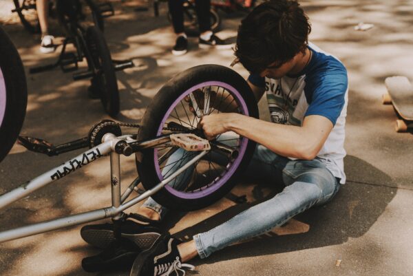 boy fixing his bicycle