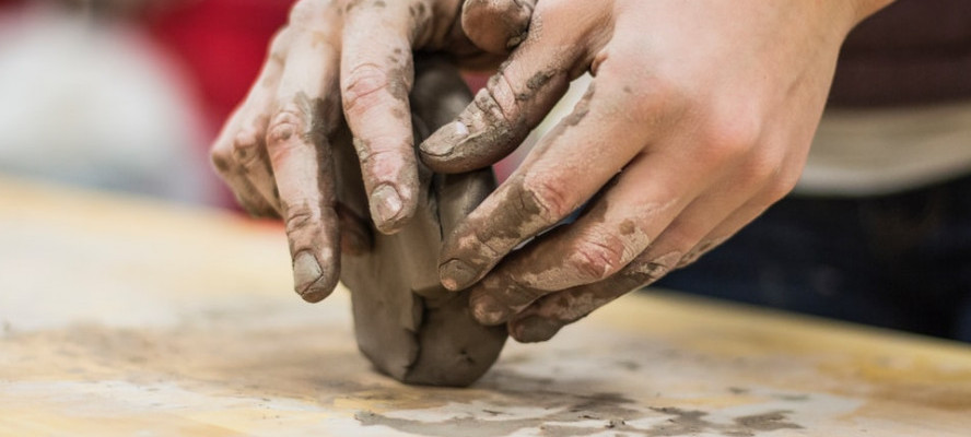 Hands sculpting clay