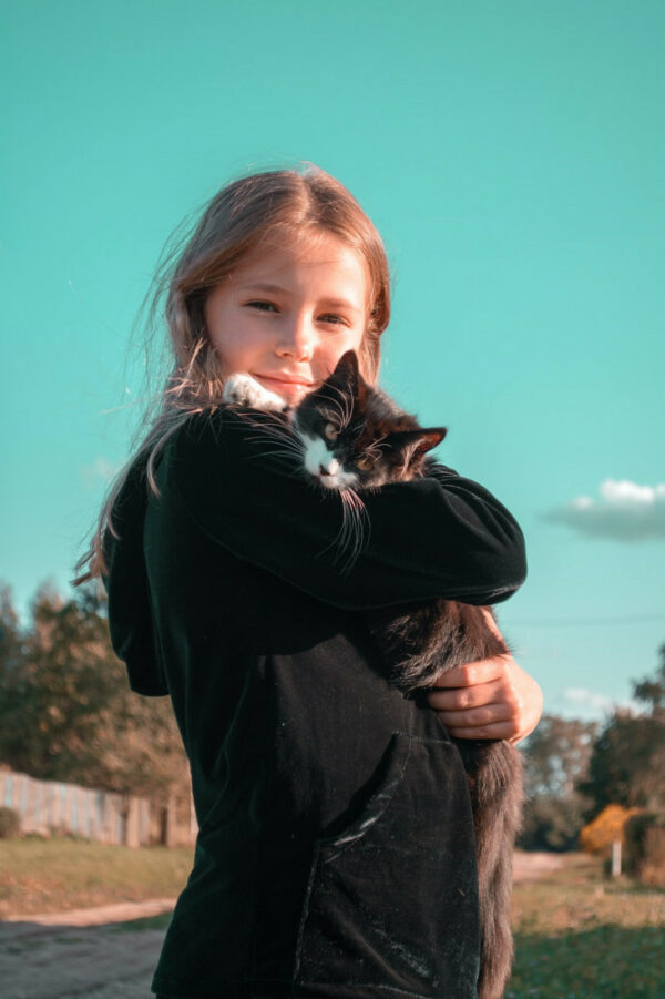 Young girl holding her cat