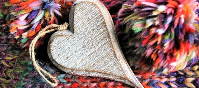 Wooden heart ornament on a knit background