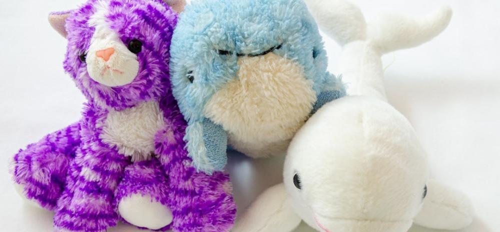 small stuffed cat, whale, and dolphin